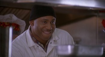 Movie still from “Deliver Us from Eva” (2003), directed by Gary Hardwick – A man wearing a hat and smiling for the camera; Close Up shot, Low angle