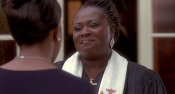 Movie still from “Deliver Us from Eva” (2003), directed by Gary Hardwick – A woman wearing a white scarf talking to another woman; Close Up shot, Over the shoulder angle