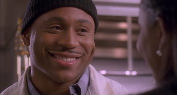 Movie still from “Deliver Us from Eva” (2003), directed by Gary Hardwick – A person wearing a jacket and a hat; Close Up shot, Low angle