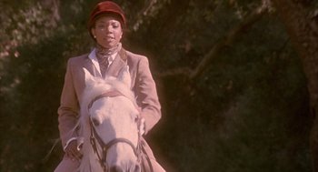Movie still from “Deliver Us from Eva” (2003), directed by Gary Hardwick – A woman riding on the back of a white horse; Close Up shot, Over the shoulder angle