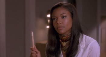 Movie still from “Deliver Us from Eva” (2003), directed by Gary Hardwick – A woman holding a pencil in her hand; Close Up shot, Over the shoulder angle