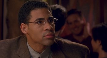 Movie still from “Deliver Us from Eva” (2003), directed by Gary Hardwick – A man with glasses in a suit; Close Up shot, Over the shoulder angle