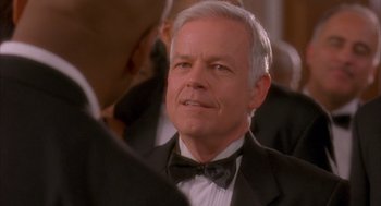 Movie still from “Deliver Us from Eva” (2003), directed by Gary Hardwick – An older man wearing a tuxedo and a bow tie; Close Up shot, Over the shoulder angle