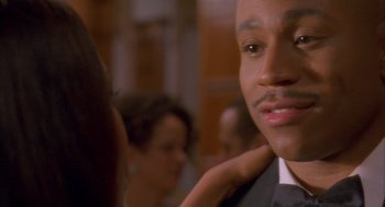 Movie still from “Deliver Us from Eva” (2003), directed by Gary Hardwick – A person wearing a suit and tie; Close Up shot, Over the shoulder angle