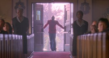 Movie still from “Deliver Us from Eva” (2003), directed by Gary Hardwick – A man standing at the door of a church; Wide shot, Low angle