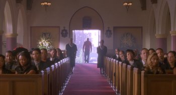 Movie still from “Deliver Us from Eva” (2003), directed by Gary Hardwick – A group of people standing in front of an open door; Extreme Wide shot, Low angle