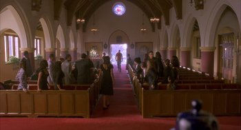 Movie still from “Deliver Us from Eva” (2003), directed by Gary Hardwick – A group of people standing in a church; Extreme Wide shot, High angle