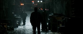 Movie still from “Deliver Us from Evil” (2014), directed by Scott Derrickson – A man standing in the rain in front of a fire truck; Wide shot, Over the shoulder angle