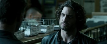 Movie still from “Deliver Us from Evil” (2014), directed by Scott Derrickson – A man sitting in front of a counter; Close Up shot, Over the shoulder angle