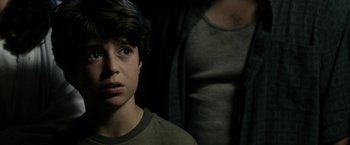 Movie still from “Deliver Us from Evil” (2014), directed by Scott Derrickson – A young boy and his father in a dark room; Close Up shot, Over the shoulder angle