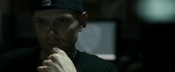 Movie still from “Deliver Us from Evil” (2014), directed by Scott Derrickson – A person wearing a black hat; Close Up shot, Low angle