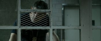 Movie still from “Deliver Us from Evil” (2014), directed by Scott Derrickson – A man standing in front of an open window; Medium shot, Over the shoulder angle