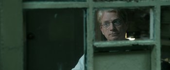 Movie still from “Deliver Us from Evil” (2014), directed by Scott Derrickson – A man with glasses looking out of a window; Close Up shot, Over the shoulder angle