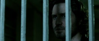 Movie still from “Deliver Us from Evil” (2014), directed by Scott Derrickson – A person looking through a fence; Close Up shot, Low angle