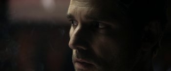 Movie still from “Deliver Us from Evil” (2014), directed by Scott Derrickson – A man's face in the dark; Extreme Close Up shot, Over the shoulder angle