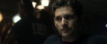 Movie still from “Deliver Us from Evil” (2014), directed by Scott Derrickson – A person wearing a black t - shirt; Close Up shot, Over the shoulder angle