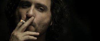 Movie still from “Deliver Us from Evil” (2014), directed by Scott Derrickson – A person with curly hair; Extreme Close Up shot, Low angle