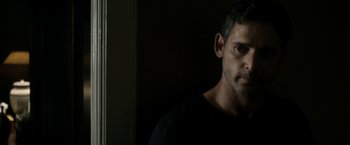 Movie still from “Deliver Us from Evil” (2014), directed by Scott Derrickson – A person wearing a black t - shirt; Close Up shot, Over the shoulder angle