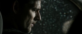 Movie still from “Deliver Us from Evil” (2014), directed by Scott Derrickson – A man's face in front of a dark background; Extreme Close Up shot, Low angle