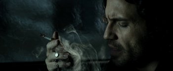 Movie still from “Deliver Us from Evil” (2014), directed by Scott Derrickson – A person smoking a cigarette; Close Up shot, Low angle