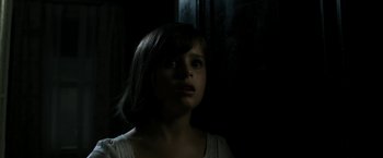 Movie still from “Deliver Us from Evil” (2014), directed by Scott Derrickson – A young girl is looking up at the ceiling; Close Up shot, Over the shoulder angle