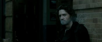 Movie still from “Deliver Us from Evil” (2014), directed by Scott Derrickson – A man with long dark hair and a black shirt; Close Up shot, Over the shoulder angle