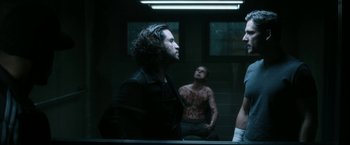 Movie still from “Deliver Us from Evil” (2014), directed by Scott Derrickson – A group of men standing next to each other in front of a mirror; Medium shot, Over the shoulder angle