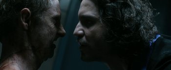 Movie still from “Deliver Us from Evil” (2014), directed by Scott Derrickson – Two men face to face in a dark room; Close Up shot, Over the shoulder angle