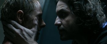 Movie still from “Deliver Us from Evil” (2014), directed by Scott Derrickson – Two men face to face in a dark room; Close Up shot, Over the shoulder angle