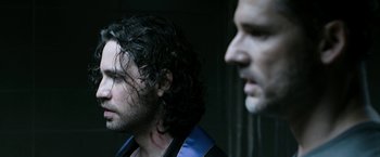 Movie still from “Deliver Us from Evil” (2014), directed by Scott Derrickson – A man with a black shirt and a beard and a man with a black shirt and a beard; Close Up shot, Over the shoulder angle