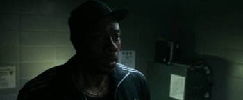 Movie still from “Deliver Us from Evil” (2014), directed by Scott Derrickson – A man in a baseball cap is looking at the camera; Close Up shot, Over the shoulder angle