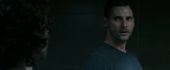 Movie still from “Deliver Us from Evil” (2014), directed by Scott Derrickson – A person wearing a black t - shirt; Close Up shot, Over the shoulder angle