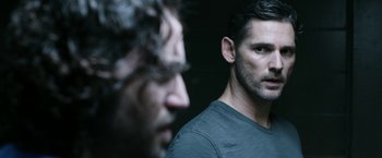 Movie still from “Deliver Us from Evil” (2014), directed by Scott Derrickson – Two men standing next to each other in front of a wall; Close Up shot, Over the shoulder angle