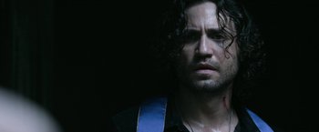 Movie still from “Deliver Us from Evil” (2014), directed by Scott Derrickson – A person with long curly hair; Close Up shot, Over the shoulder angle