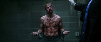 Movie still from “Deliver Us from Evil” (2014), directed by Scott Derrickson – A man with blood all over his face and chest; Medium shot, High angle