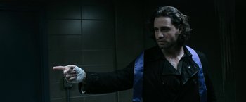 Movie still from “Deliver Us from Evil” (2014), directed by Scott Derrickson – A man in a black jacket is holding something in his hand; Medium shot, Over the shoulder angle