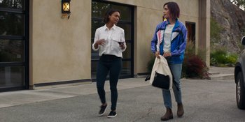 Movie still from “Demonic” (2021), directed by Neill Blomkamp – Two women are walking down the street talking to each other; Medium shot, Over the shoulder angle