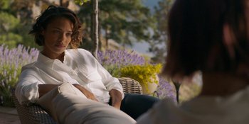 Movie still from “Demonic” (2021), directed by Neill Blomkamp – Two women are sitting on a chair outside; Medium shot, Over the shoulder angle