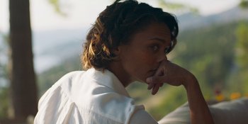 Movie still from “Demonic” (2021), directed by Neill Blomkamp – A woman in a white shirt is touching her chin; Close Up shot, Over the shoulder angle