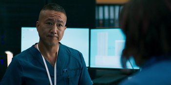 Movie still from “Demonic” (2021), directed by Neill Blomkamp – A man in a blue shirt is looking at the camera; Close Up shot, Over the shoulder angle