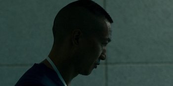 Movie still from “Demonic” (2021), directed by Neill Blomkamp – A person's head with a brick wall in the background; Close Up shot, Low angle