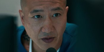 Movie still from “Demonic” (2021), directed by Neill Blomkamp – A person with a microphone; Close Up shot, Over the shoulder angle