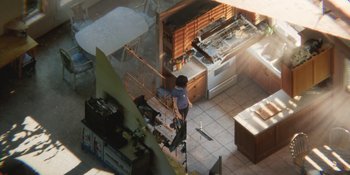 Movie still from “Demonic” (2021), directed by Neill Blomkamp – A woman standing in a kitchen next to an oven; Extreme Wide shot, High angle