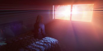 Movie still from “Demonic” (2021), directed by Neill Blomkamp – A woman sitting on a bed looking out of a window; Wide shot, Low angle