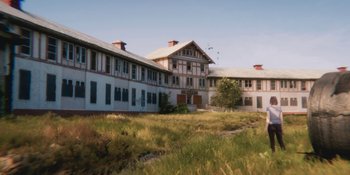 Movie still from “Demonic” (2021), directed by Neill Blomkamp – An old white building sitting on top of a grass covered field; Extreme Wide shot, Low angle