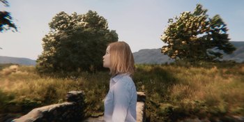 Movie still from “Demonic” (2021), directed by Neill Blomkamp – A woman standing in the grass near some trees; Medium shot, Over the shoulder angle