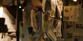 Movie still from “Demonic” (2021), directed by Neill Blomkamp – A wall covered with lots of books and papers; Extreme Close Up shot, High angle