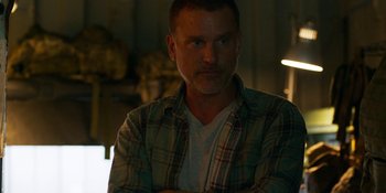 Movie still from “Demonic” (2021), directed by Neill Blomkamp – A person wearing a plaid shirt; Close Up shot, Over the shoulder angle