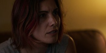 Movie still from “Demonic” (2021), directed by Neill Blomkamp – A person with red hair looking at the camera; Close Up shot, Over the shoulder angle