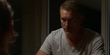 Movie still from “Demonic” (2021), directed by Neill Blomkamp – A person sitting in a room; Close Up shot, Over the shoulder angle